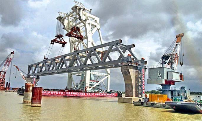 A crane is seen installing a span on the pillar of the under construction Padma bridge site in this file photo.