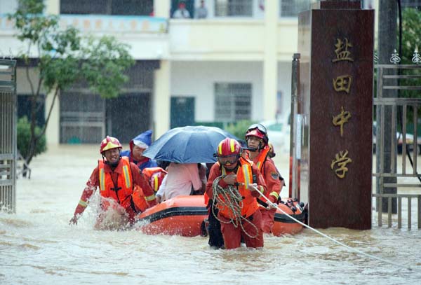 Rescue workers evacuate with an inflatable boat students stranded by floodwaters at a school, amid heavy rainfall in Duchang county, Jiangxi province, China on Friday. Internet