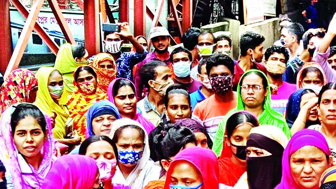 Workers of J.K. Garments blocked road demanding their arrear salaries in the city's Shewrapara area on Saturday.
