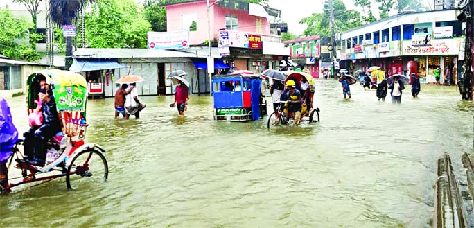 Sunamganj goes under flood water for the second time in this season due to unusual rise in the water level of River Surma. The photo was taken from Sholghar point area on Sunday.