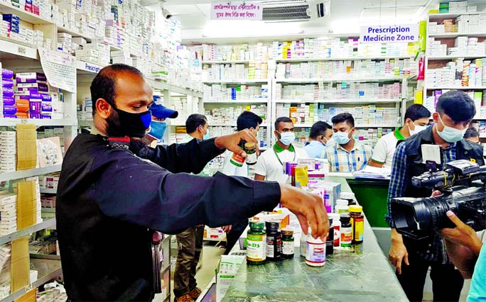 A mobile court of Rapid Action Battalion (RAB) conducts drive at the Lazz Pharma's Kakrail branch in the capital on Monday. The court fined it Tk 29 lakh after seizure of huge non-approved and banned drugs from the store.