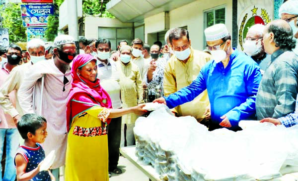 Jatiya Party Chairman GM Kader, MP distributes foodstuff among the distressed people at the party central office in the city's Kakrail on Friday marking the first death anniversary of the party founder Hussain Muhammad Ershad.