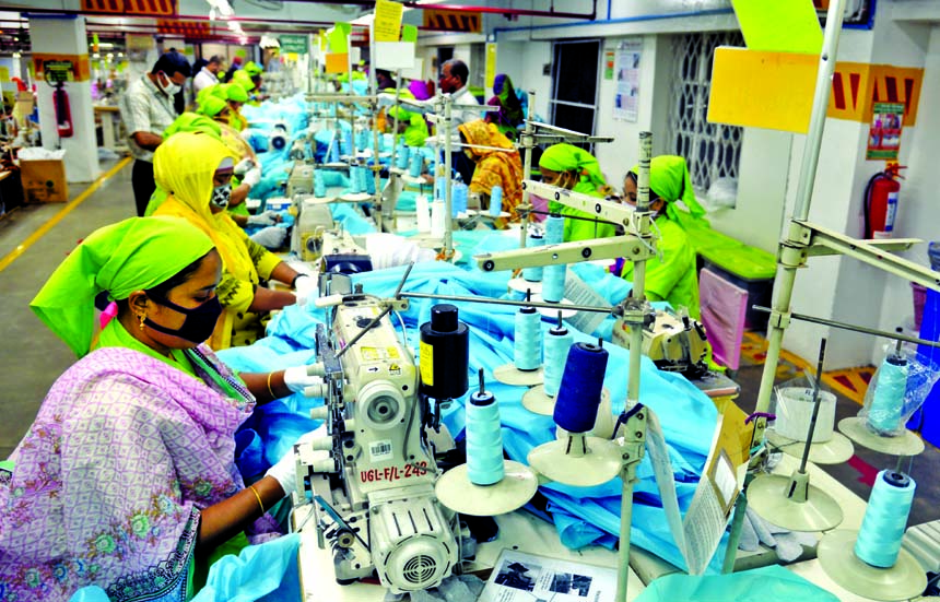 Female workers are seen working at a garment factory in the capital on Thursday wearing masks and maintaining phyhical distance amid spread of coronavirus.