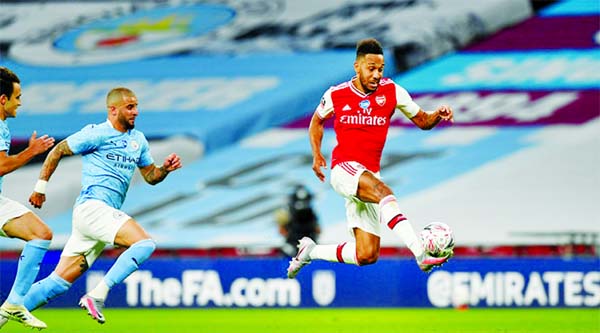 Arsenal's Pierre-Emerick Aubameyang (right) in action with Manchester City's Kyle Walker at an empty Wembley Stadium on Saturday.