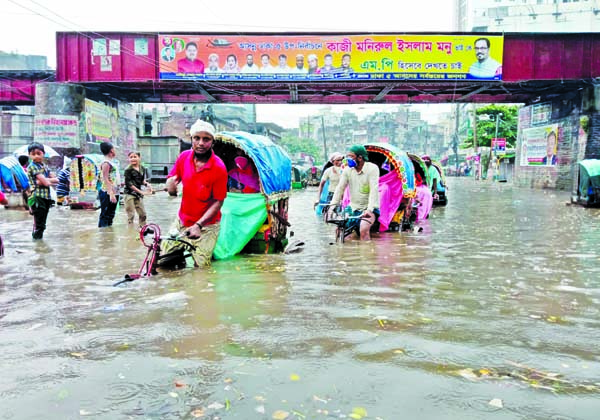 Doyagonj road in the capital goes under knee-deep water following Tuesdayâ€™s heavy rainfall.