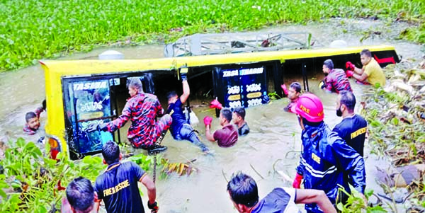 Fire Service personnel conducts rescue operation after a passenger bus fell into a roadside ditch at Zaligaon -Nilpur Bazar under Sunamganj Sadar upazila on Tuesday.