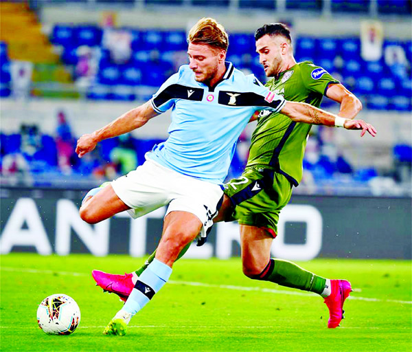 Lazio's Ciro Immobile (left) vies with Cagliari's Charalampos Lykogiannis during the Serie A football match between Lazio and Cagliari in Rome, Italy on Thursday. Lazio won the match 2-1.