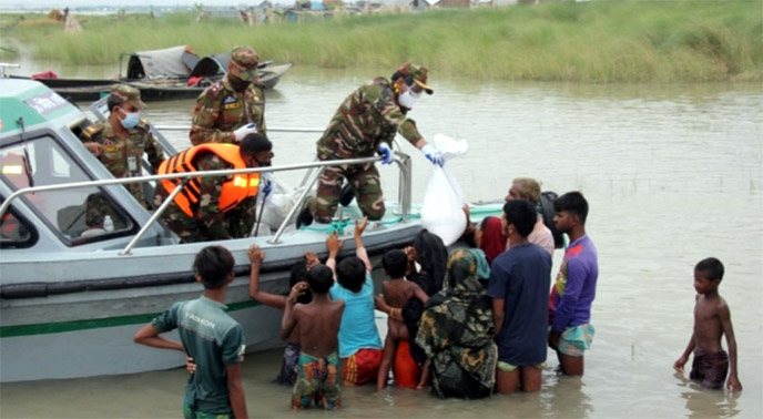 Bangladesh Army distributes relief materials among the distressed people in flood-hit areas in Shariatpur on Friday.