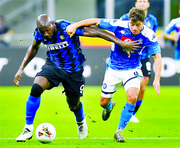 FC Inter's Romelu Lukaku (left) vies with Napoli's Diego Demme during a Serie A football match between FC Inter and Napoli in Milan, Italy on Tuesday.