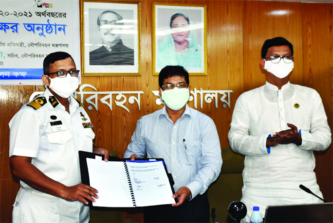 Secretary of Shipping Ministry Mesbah Uddin Chowdhury and BIWTA Chairman Commodore Golam Sadeq exchange documents after signing 11 Annual Performance Agreements for 2020-2021 Fiscal Year with different organisations associated with the ministry at its co
