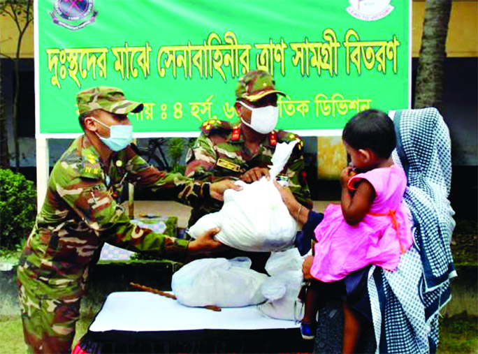 A team of the Bangladesh Army in Rangpur distributes reliefs among the poor people on Wednesday.