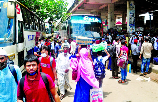 The home-bound Eid passengers gather at bus terminals caring none, even the health guidelines, risking transmission of coronavirus. The photo was taken from Mohakhali Bus Terminal.