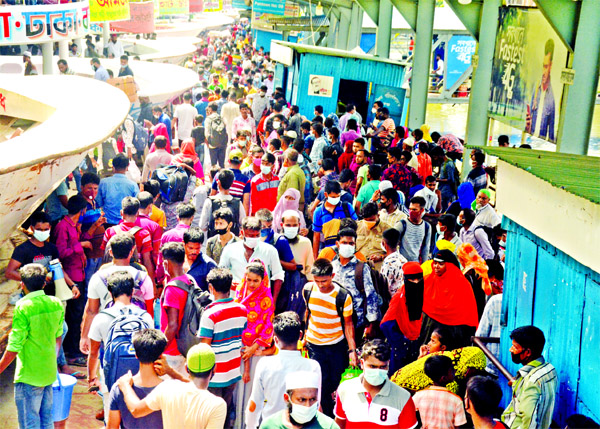 Thousands of home-bound Eid passengers throng Sadarghat Launch Terminal on Thursday ignoring coronavirus fear.