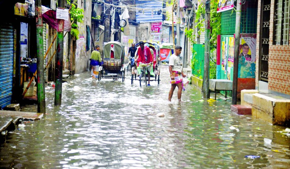 Incessant rains lash Dhaka on Tuesday morning lead to water-logging in many parts of the city. In this photo, rickshaws wade through an inundated Aga Sadek Road (Saatrowja) in Old Dhaka.