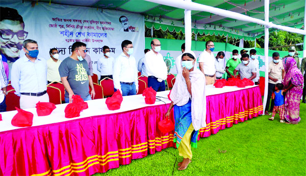 Officials of Bangladesh Cricket Board (BCB) distribute food to the distressed people in front of the Sher-e-Bangla National Cricket Stadium in the city's Mirpur marking the 71st birth anniversary of Shaheed Sheikh Kamal on Wednesday.