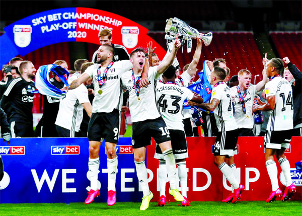 Fulham's Tom Cairney (front left) and Fulham's Aleksandar Mitrovic (front right) celebrate promotion to the Premier League with teammates after winning the Championship play-off final against Brentford at Wembley Stadium on Tuesday.