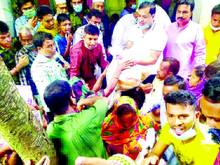 Mayor of Gazipur City Corporation Advocate Zahangir Alam distributes relief materials among the flood-affected people in Lathibhanga and Kaliakoir on Wednesday.