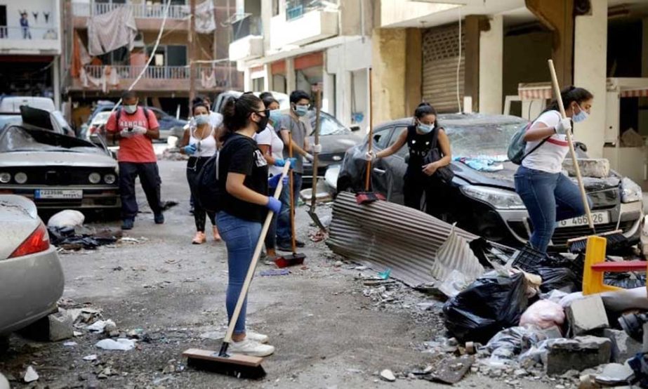Volunteers clean the streets following Tuesday's blast in Beirut's port area, Lebanon on Thursday.
