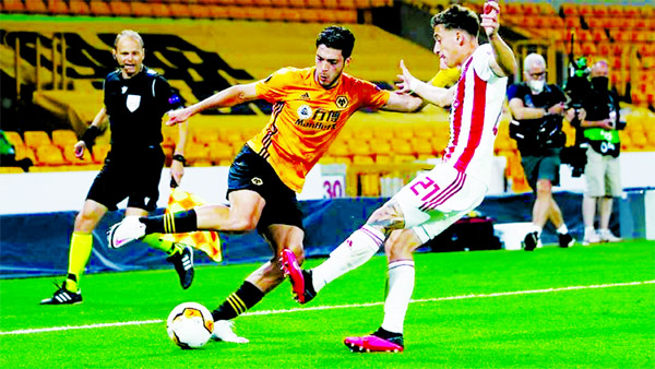 Wolverhampton Wanderers' Raul Jimenez in action with Olympiakos' Konstantinos Tsimikas (right) during their Europa League Football match on Thursday.