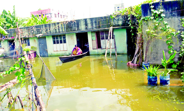 Due to swelling in the water level of rivers around Dhaka, the low-lying areas in the capital have been submerged by flood water forcing the people to move by boats. This photo was taken from Kusumbagh area under city's Sabujbagh on Friday.