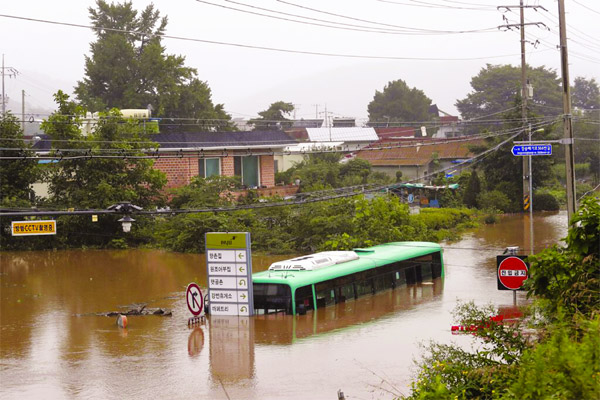 A bus is submerged in floodwaters following heavy rains on Thursday in Paju, South Korea on Saturday.