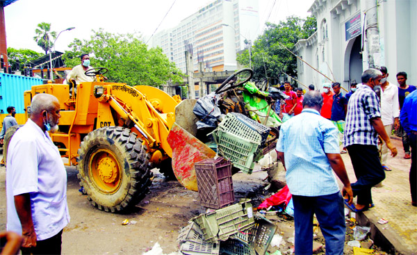 Dhaka South City Corporation conducts a drive on Sunday to evict illegal structures in front of emergency gate of Dhaka Medical College Hospital.