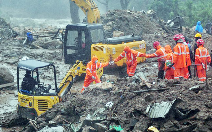 Rescue workers look for survivors at the site of a landslide during heavy rains in Idukki, Kerala on Sunday.