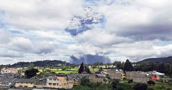 Mount Sinabung spews volcanic materials into the air as it erupts, in Karo, North Sumatra, Indonesia.