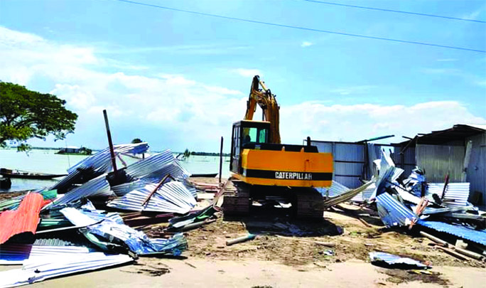 Kishorganj district administration conducts a drive on Monday to evict illegal structures and recovered government land at Karpasha in Nikli Haor Upazila of Kishorganj.