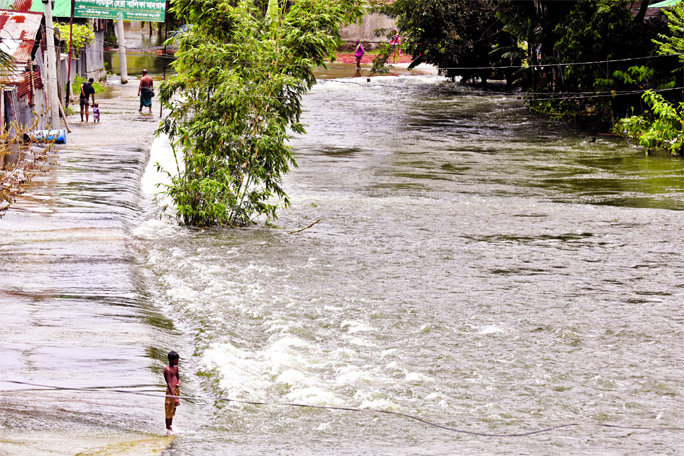 Many low-lying areas in the capital city Dhaka has already been gone under flood water. This photo, taken on Monday, shows that the main road at Amin Bazar area inundated due to onrush of water.