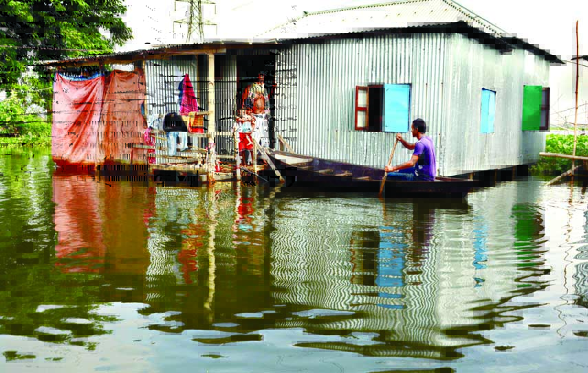 Different low-lying areas in Dhaka have already been submerged by the floodwater where dwellers have no other way but to use small boats for moving even for household works. This photo was taken from Khilgaon area on Tuesday.