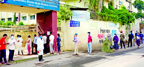 People are seen showing more interest nowadays in testing Coronavirus at public hospitals, when private hospitals are caught in fraudulence one after another with providing fake Covid-19 certificates. This photo, taken on Wednesday from Bangabandhu Sheikh