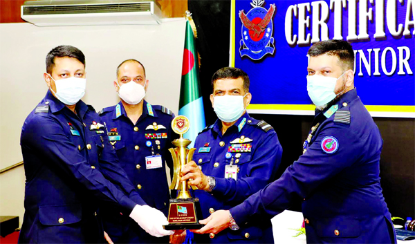 BAF Assistant Chief of Air Staff (Operations) Air Vice Marshal M Abul Bashar hands over 'Chief of Air Staff's Trophy' to Squadron Leader ABM Golam Sadik for his best performance No. 114 Junior Command and Staff Course held at Falcon Hall, Dhaka on Thur