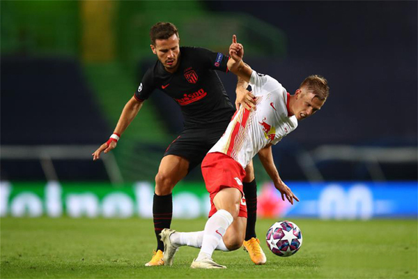 Dani Olmo (right) of RB Leipzig vies with Saul Niguez of Atletico Madrid during the 2019-2020 UEFA Champions League quarter-final match between RB Leipzig and Atletico Madrid in Lisbon, Portugal on Thursday.