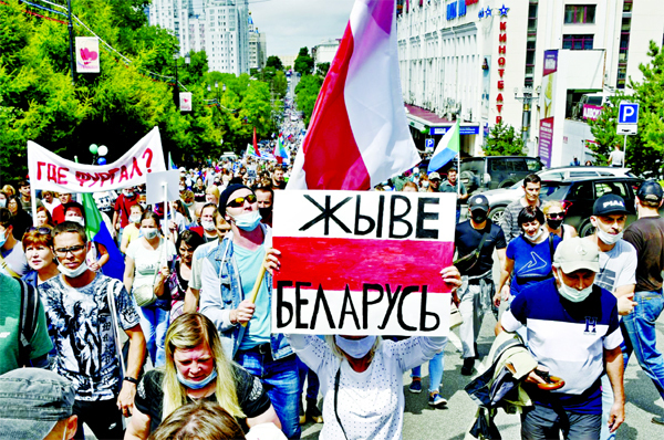 People hold a poster reading "Long live Belarus" during an unsanctioned protest in support of Sergei Furgal, the governor of the Khabarvosk region, east of Moscow, Russia on Saturday.