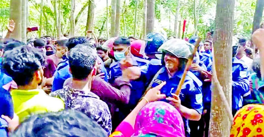 Agitated people hold policemen captive for their alleged involvement in a murder in Kalukhali upazila of Rajbari on Saturday.