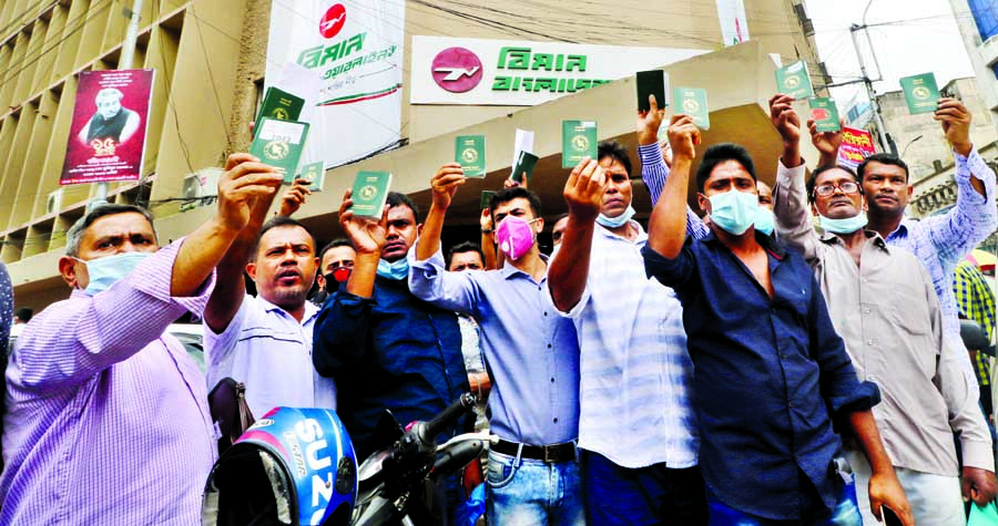 Migrant workers stage protest holding up their passports in front of Biman's Motijheel office in the capital on Monday amid crisis in air tickets.