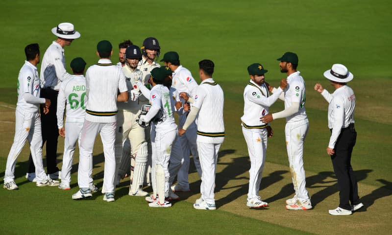 Players and umpires bump arms after agreeing to end the game as a draw on the fifth day of the second Test match between England and Pakistan at the Ageas Bowl in Southampton on Monday.
