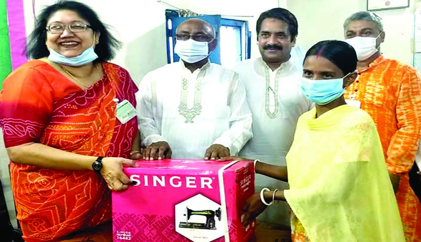 State Minister for Social Welfare Ashraf Ali Khan Khasru distributes sewing machines among the poor women in Netrakona on Tuesday to help them self-reliant. President of district Mahila Awami League and social worker Kamrunnesa Ashraf Dina and local Awami