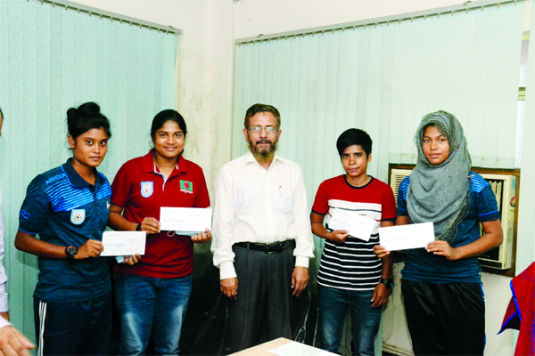 The booters of Bangladesh Under-15 Women's Football team, who accorded reception by Janata Bank Limited with an official of Janata Bank Limited pose for a photo session at the Head Office of Janata Bank Limited on Thursday.