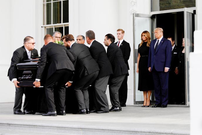 President Donald Trump and First Lady Melania Trump accompany Robert Trump's casket.