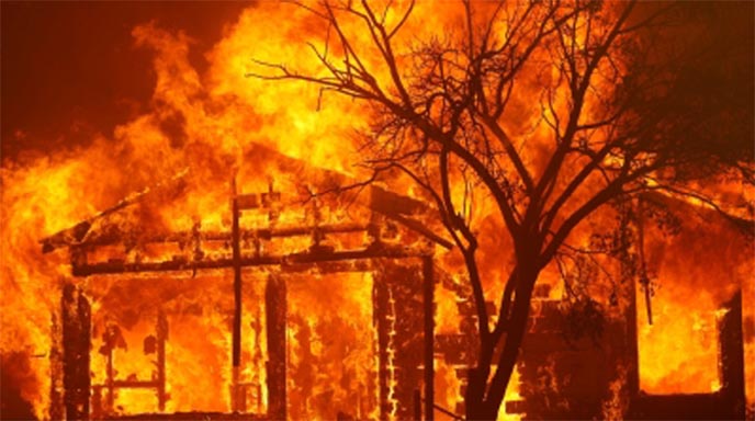 A burning home is seen along Cherry Glen Road during the LNU Lighting Complex Fire on the outskirts of Vacaville, California, the US.