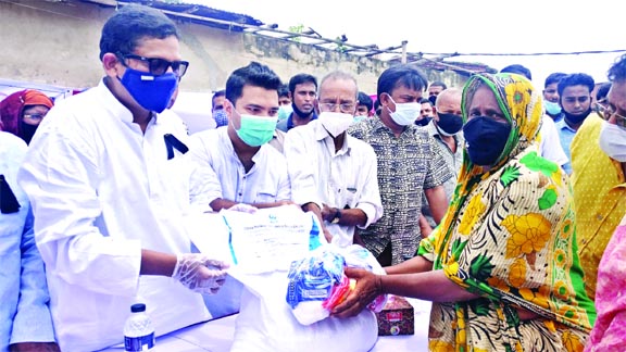 State Minister of ICT Ministry Zunaid Ahmed Palak distributes relief materials among the flood affected families at Singra in Natore on Saturday.