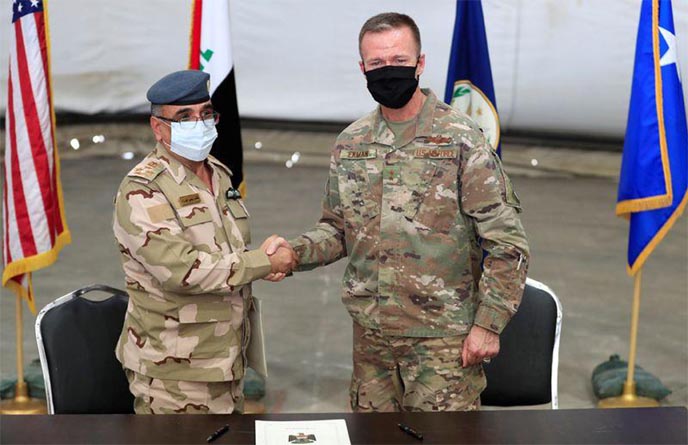 Maj. Gen. Kenneth P. Ekman, Deputy Commander of Combined Joint Task Force-Operation Inherent Resolve, shakes hand with Brigadier General Salah Abdullah during a handover ceremony of Taji military base from US-led coalition troops to Iraqi security forces,