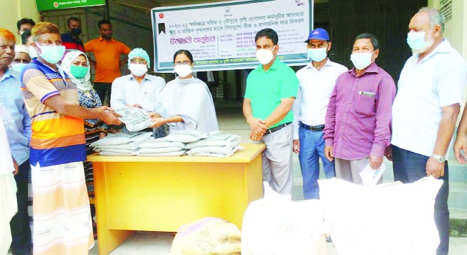 Taslima Begum, Upazila Nirbahi Officer of Gangachara in Rangpur, distributes seeds and fertilizer among the local farmers on Monday.