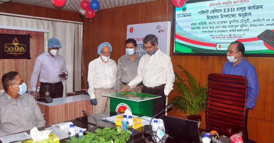 Abu Hena Md Rahmatul Muneem, Chairman of the National Board of Revenue (NBR), inaugurating the installation of Electronic Fiscal Device (EFD) at Rajswa Bhaban in Segunbagicha in the capital on Tuesday. Mohammad Muslim Chowdhury, Comptroller and Auditor Ge
