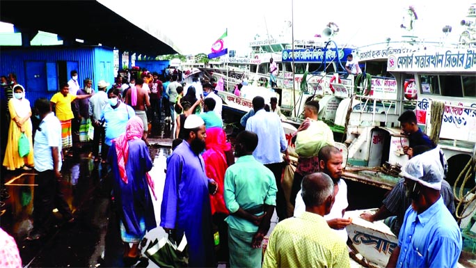 Passengers stranded at Barishal Launch Terminal after the authorities restricted plying water transports due to rough weather condition on Wednesday.