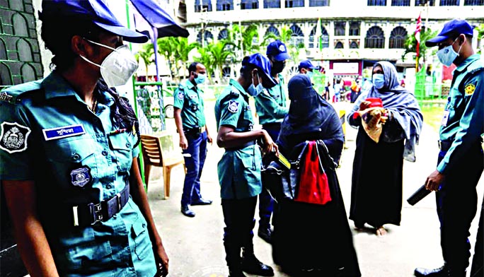 Dhaka Metropolitan Police (DMP) tightens security around the Hussaini Dalan Imambara in Old Dhaka ahead of the Holy Ashura. This photo was taken on Friday shows police personnel search a woman's purse in front of the Hussaini Dalan to avoid any unexpecte