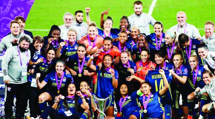Lyon players pose with the trophy after winning the Women's Champions League final match against Wolfsburg at the Anoeta Stadium in San Sebastian, Spain on Sunday.