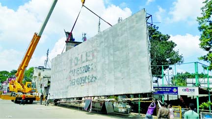 A hydraulic crane is seen removing an illegal billboard from the Hazrat Shahjalal International Airport area in the capital on Wednesday as a Dhaka North City Corporation mobile court launched an eviction drive to remove illegal billboard from there.